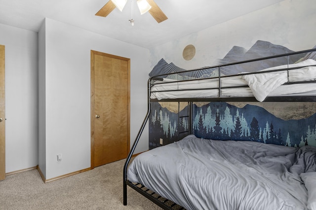 carpeted bedroom with baseboards and ceiling fan