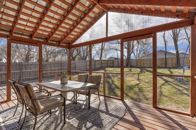 unfurnished sunroom featuring a healthy amount of sunlight and vaulted ceiling