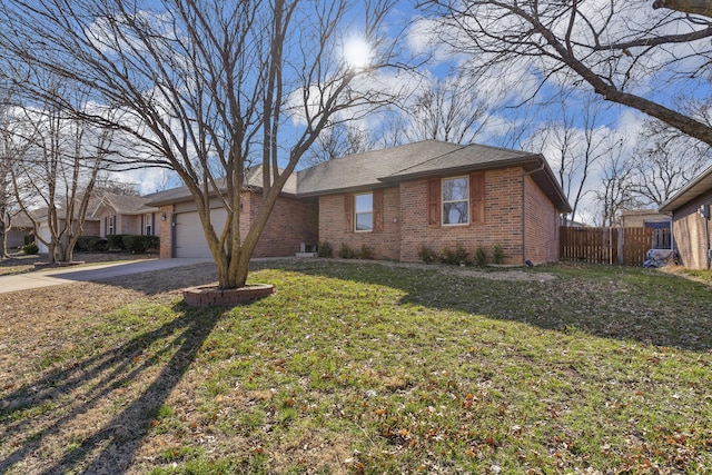 ranch-style home with brick siding, a front lawn, fence, concrete driveway, and an attached garage