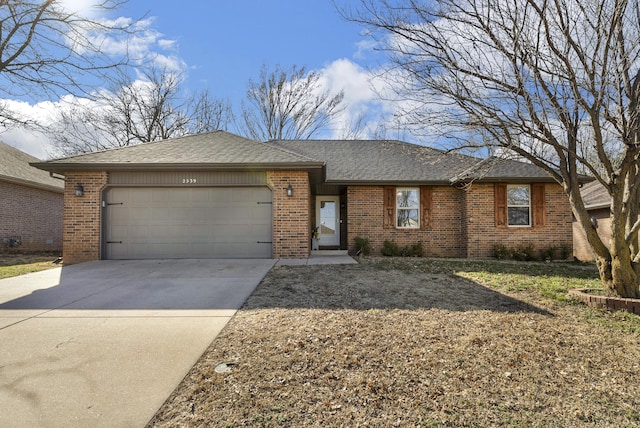 ranch-style home with brick siding, roof with shingles, concrete driveway, and an attached garage