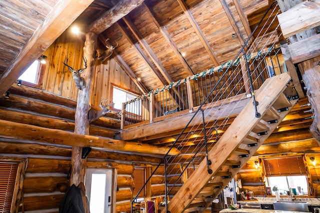 room details featuring rustic walls, beamed ceiling, wooden ceiling, and a sink