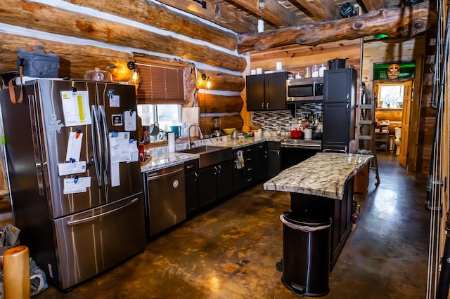 kitchen with a sink, stainless steel appliances, rustic walls, and light stone counters