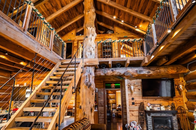 stairway featuring beamed ceiling, high vaulted ceiling, and wood ceiling