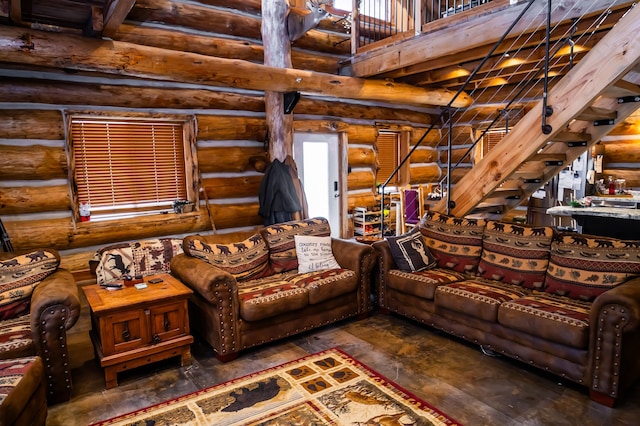 living room featuring stairway, a high ceiling, and wood-type flooring