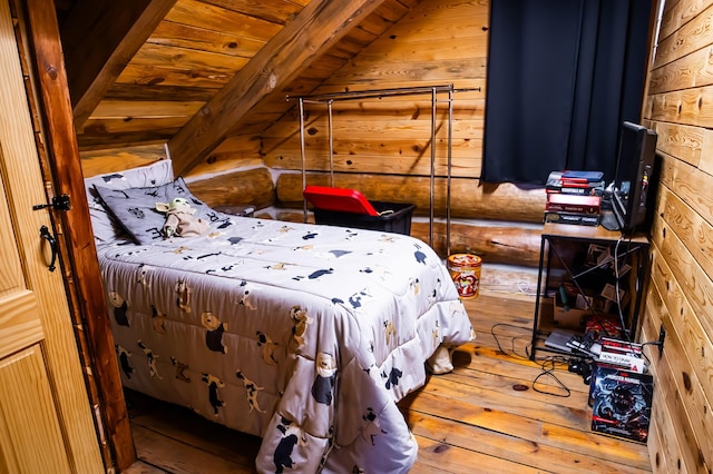 bedroom with lofted ceiling with beams, rustic walls, wood-type flooring, wood walls, and wood ceiling