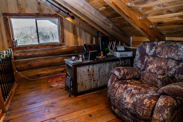 sitting room featuring hardwood / wood-style floors, lofted ceiling with beams, and log walls