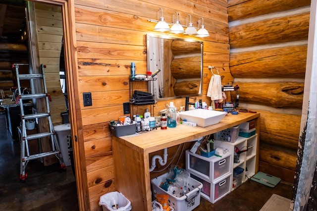 office space with rustic walls and a sink