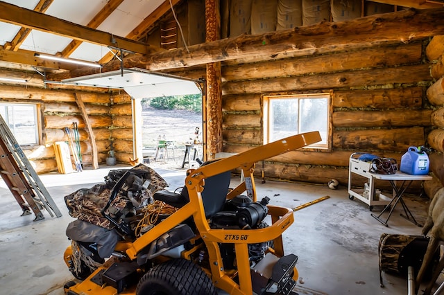 misc room with log walls, a garage, and high vaulted ceiling