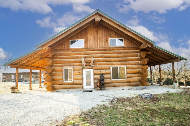 back of property with an outbuilding and log exterior