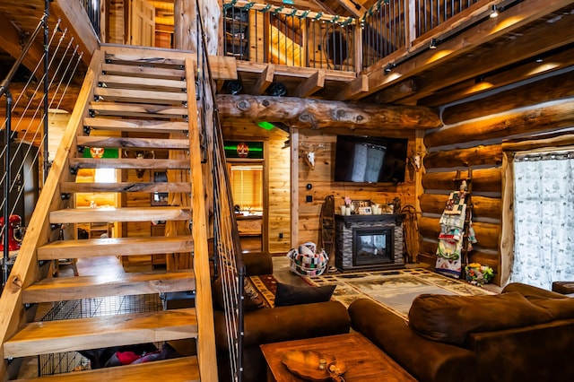 living room featuring log walls and a high ceiling