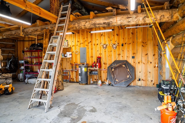 garage featuring electric panel, electric water heater, and wood walls