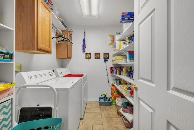 washroom with light tile patterned floors, cabinet space, and separate washer and dryer