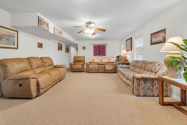 carpeted living area featuring ceiling fan