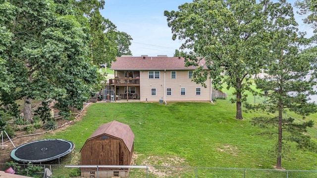 back of property featuring an outdoor structure, stairway, a yard, and a fenced backyard