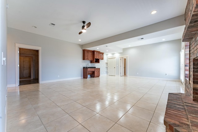 unfurnished living room featuring light tile patterned floors, baseboards, recessed lighting, and a fireplace