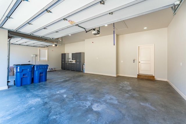 garage with baseboards and a garage door opener