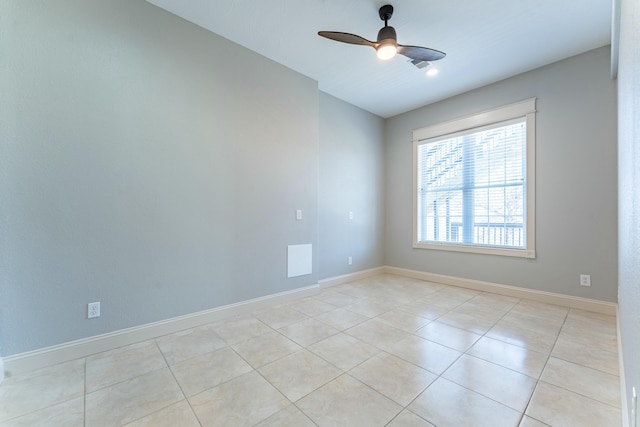 unfurnished room featuring light tile patterned floors, baseboards, and ceiling fan