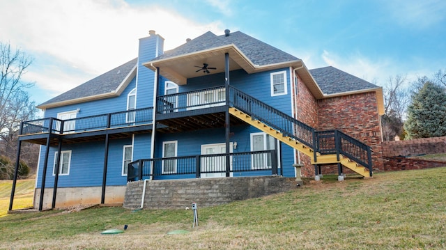 back of house with stairway, a lawn, a chimney, and a ceiling fan