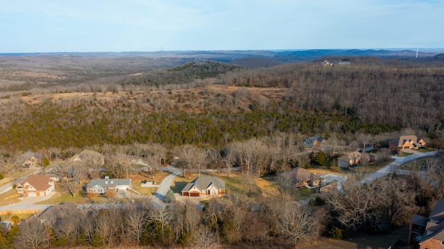 birds eye view of property with a view of trees