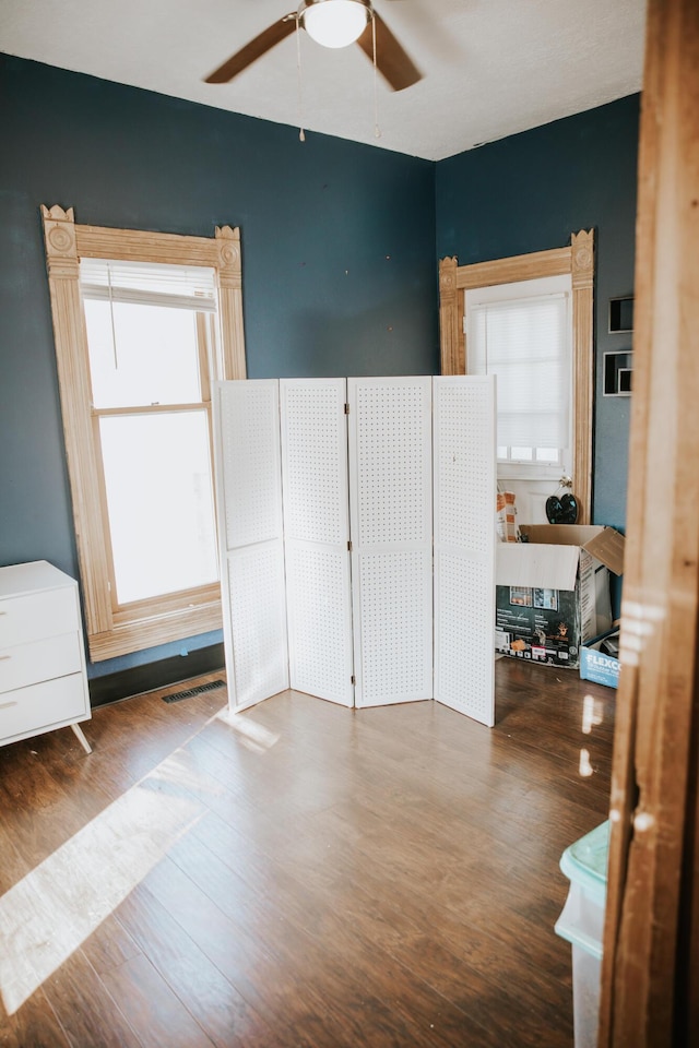 interior space featuring visible vents, wood finished floors, and a ceiling fan