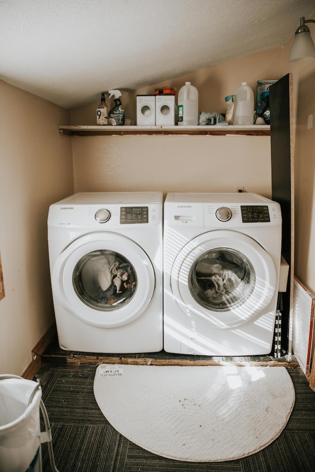 clothes washing area featuring laundry area and washing machine and clothes dryer