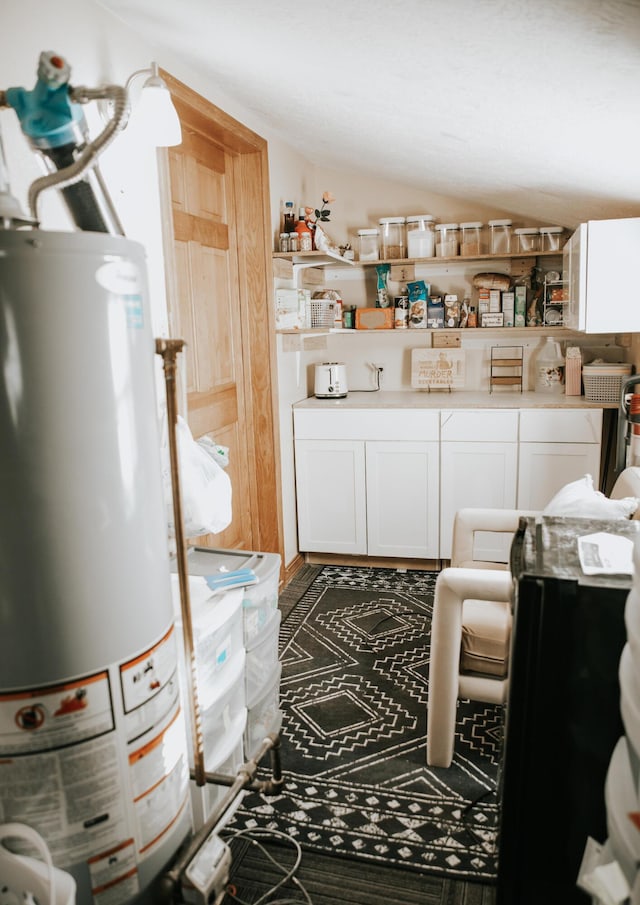 interior space with water heater and vaulted ceiling