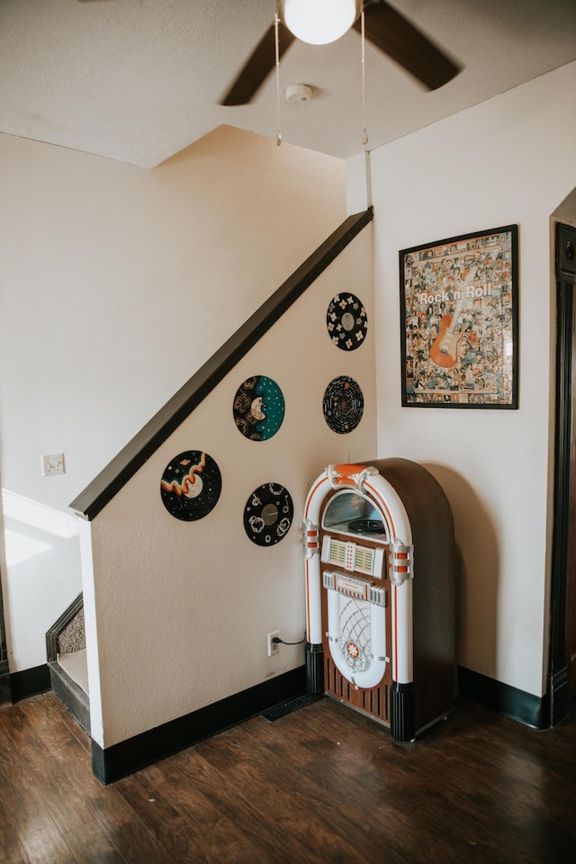 interior details featuring baseboards, ceiling fan, and wood finished floors