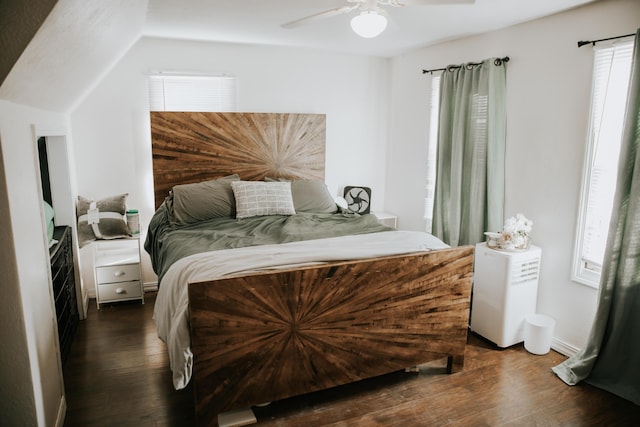 bedroom featuring multiple windows, dark wood-type flooring, and a ceiling fan