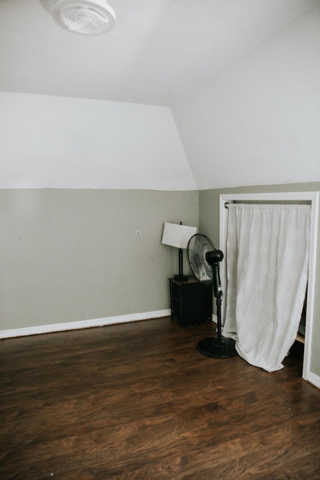 bonus room featuring vaulted ceiling, wood finished floors, and baseboards