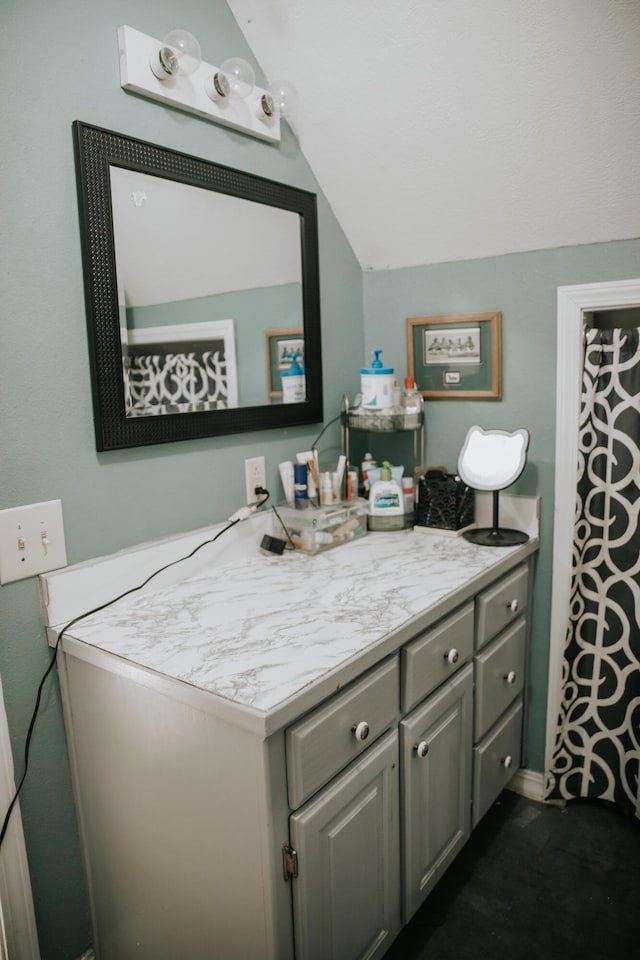 bathroom featuring vanity and vaulted ceiling