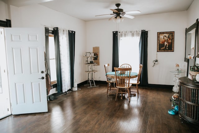 dining room featuring baseboards, wood finished floors, and ceiling fan