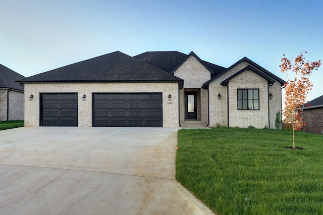 view of front facade with concrete driveway, brick siding, a garage, and a front lawn