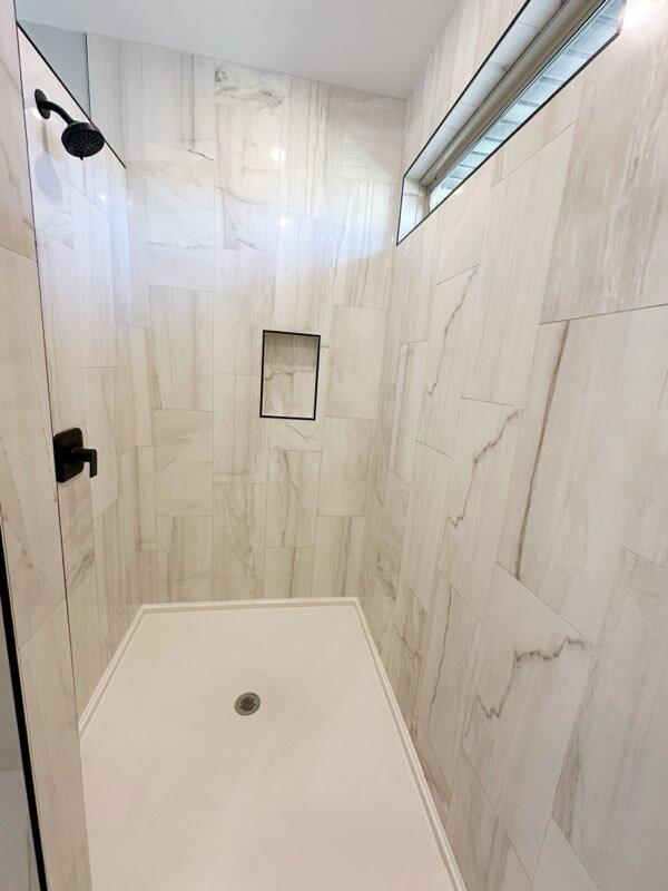 bathroom with a tile shower