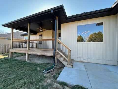 property entrance with a yard and fence