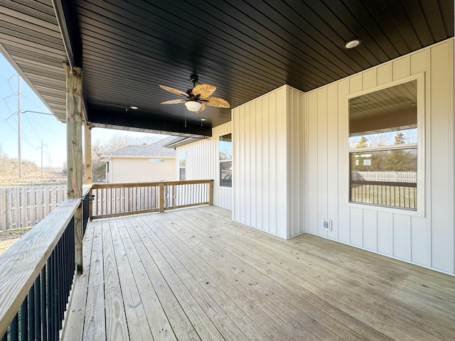 wooden terrace featuring ceiling fan and fence