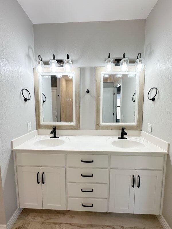 bathroom with double vanity and a sink