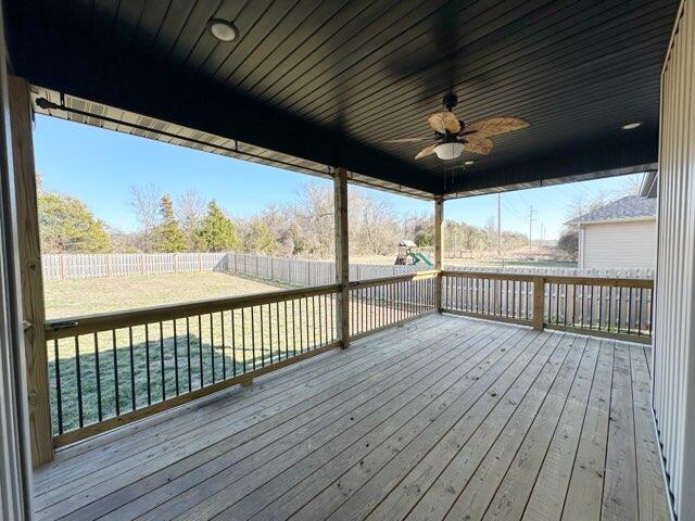 wooden deck with a fenced backyard and a ceiling fan