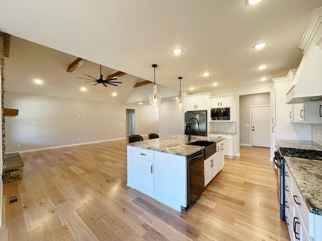 kitchen with a sink, decorative backsplash, range with gas stovetop, and black dishwasher