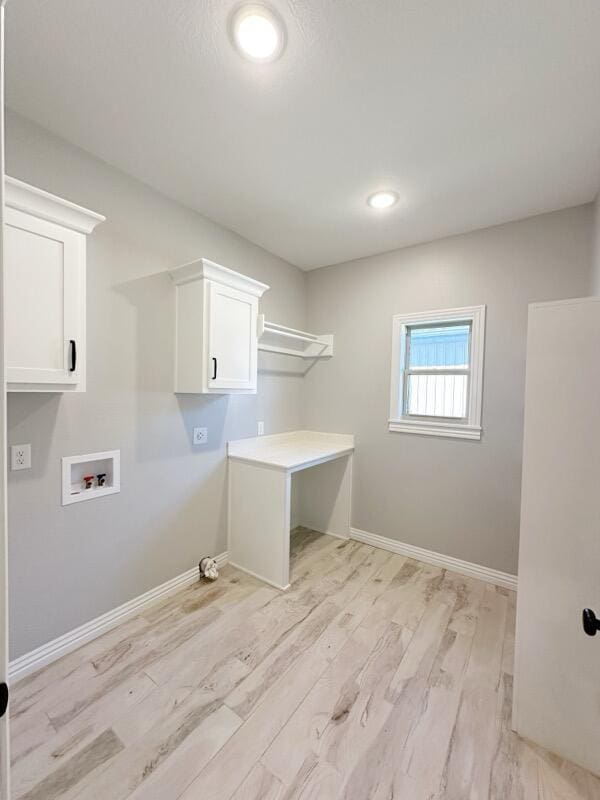 laundry area with baseboards, cabinet space, light wood-style floors, and hookup for a washing machine