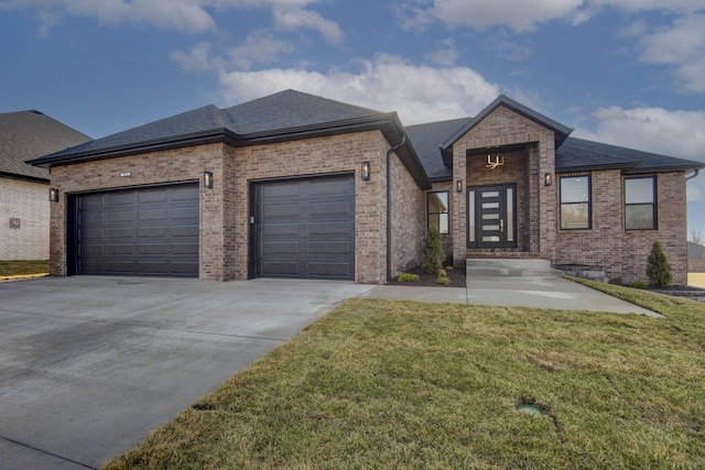 view of front of property featuring driveway, an attached garage, a shingled roof, a front yard, and brick siding