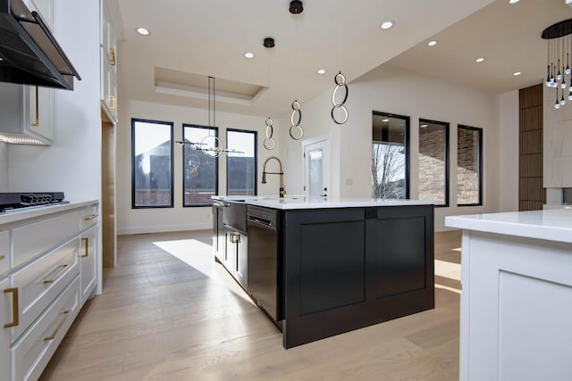 kitchen featuring black appliances, white cabinets, light countertops, and under cabinet range hood