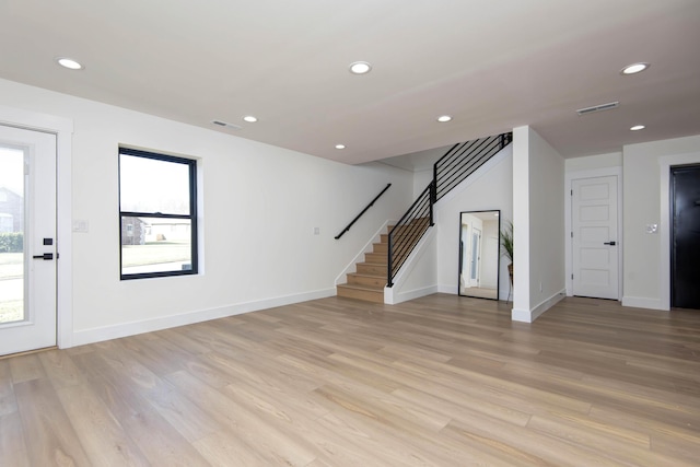 unfurnished living room with recessed lighting, visible vents, and light wood-style floors