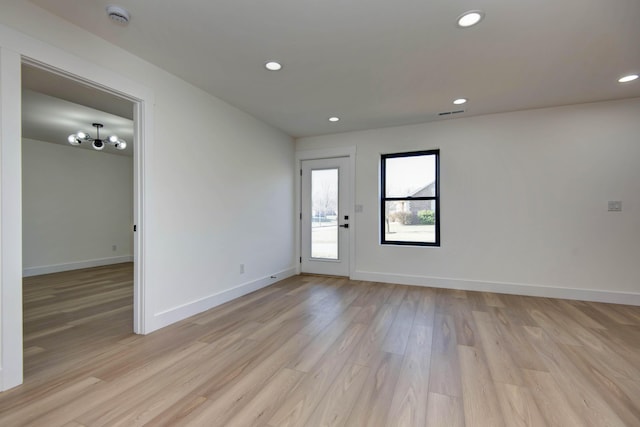 unfurnished room featuring recessed lighting, light wood-style flooring, and baseboards