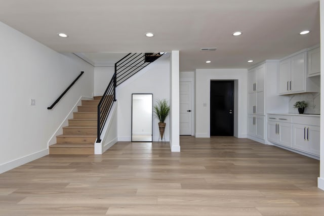 interior space featuring stairs, recessed lighting, visible vents, and light wood-type flooring