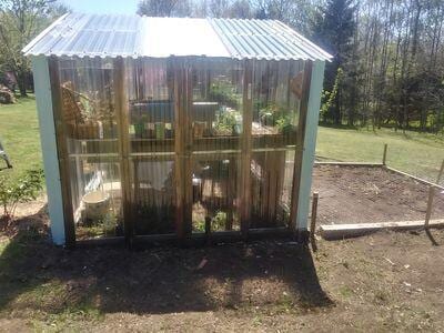 view of greenhouse featuring a lawn