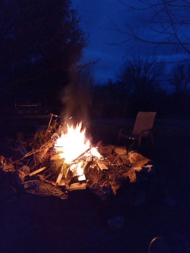 exterior details featuring an outdoor fire pit