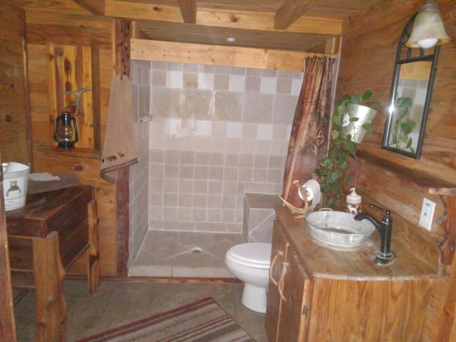 bathroom with a shower with curtain, toilet, tile walls, tile patterned flooring, and vanity