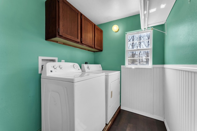 laundry room with a wainscoted wall, dark wood-style floors, cabinet space, and independent washer and dryer