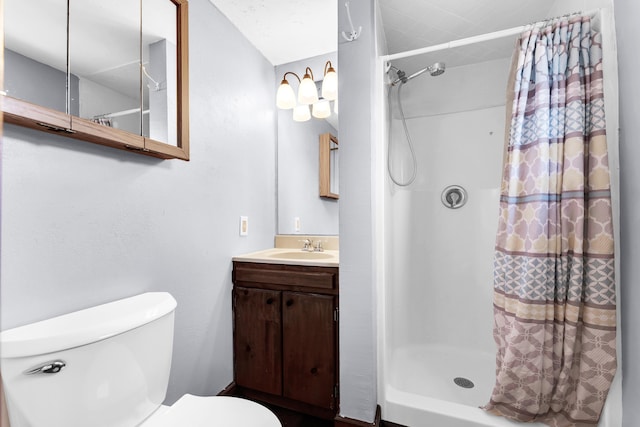 bathroom featuring vanity, toilet, and a shower stall