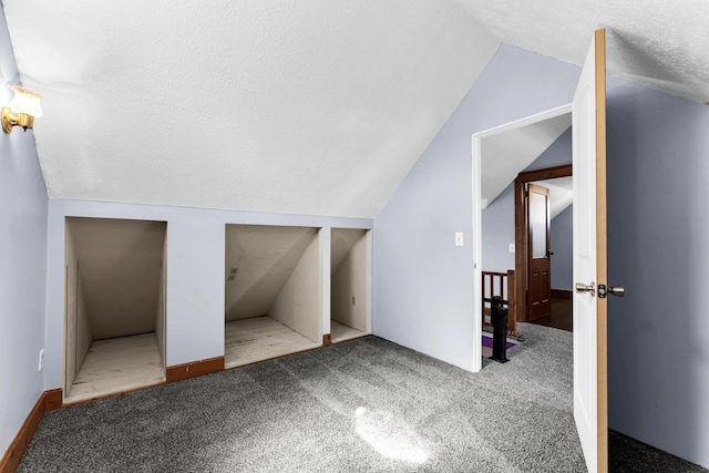 bonus room with vaulted ceiling, carpet flooring, and a textured ceiling